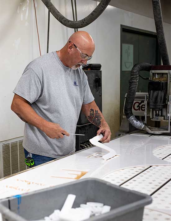 Engraphix CNC Router Operator Cutting dimensional letters for custom exterior sign