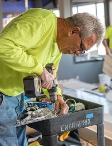 Engraphix Installer installing wall logo for World Wide Technology