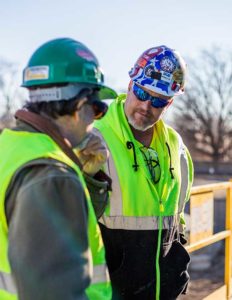 Install Crew member talking to sales team representative at Engraphix sign install job sight