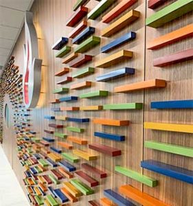 Colorful Dimensional plaques on wood wall for donor wall display