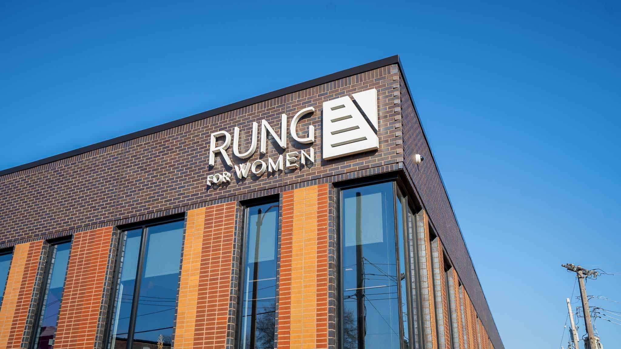 White acrylic exterior sign mounted on top of a building for rung for women