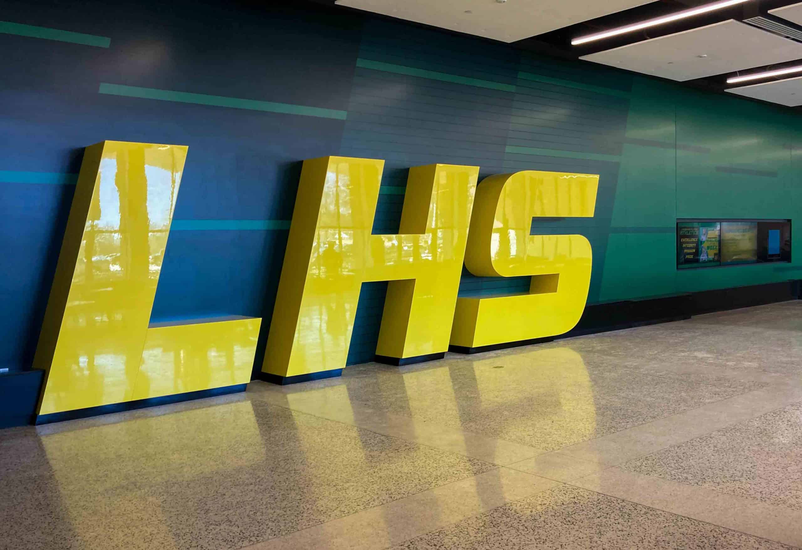 giant yellow dimensional LHS against a vinyl graphic decorated wall