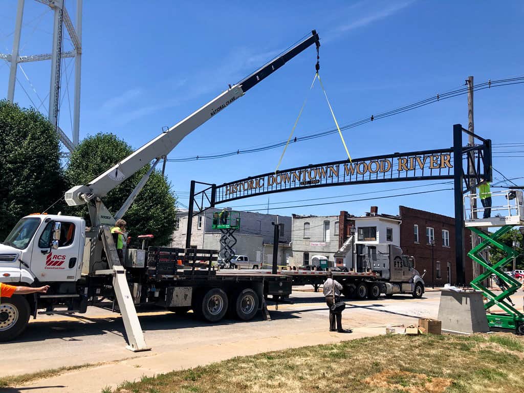 Installing large archway with boom truck
