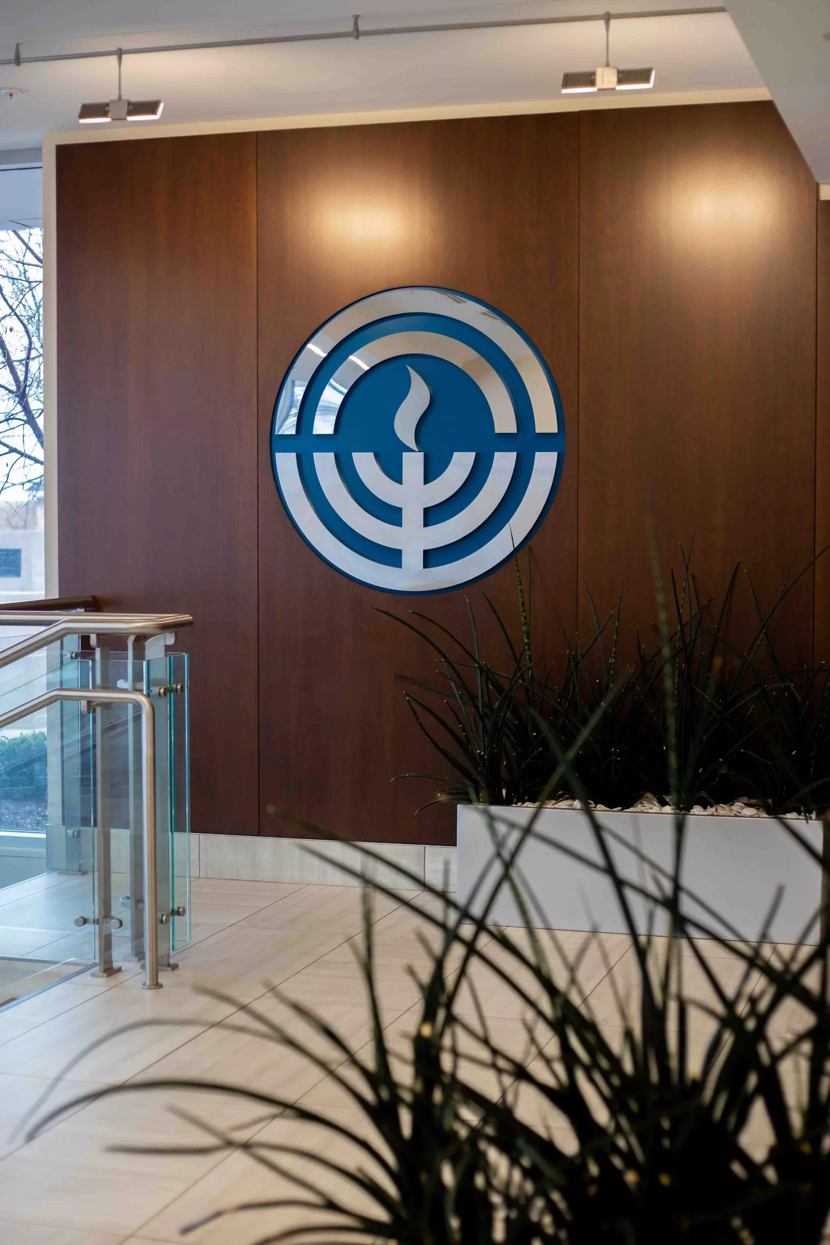 Jewish Federation with dimensional logo against wood