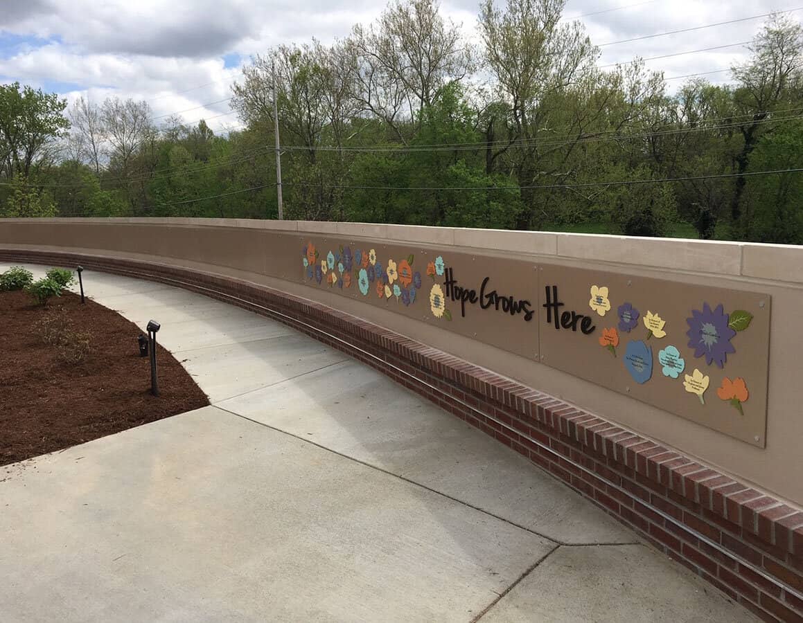 monument sign donor wall with flowers for hope grows here campaign