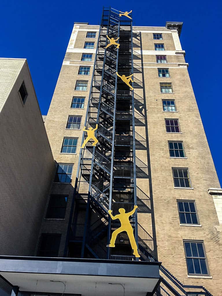 Large People Climbing up tall building