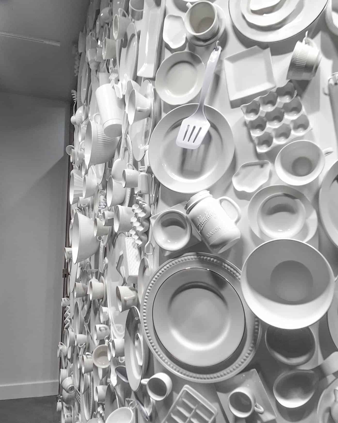 Up close image of sculptural wall made out of white dishes at the Eatery