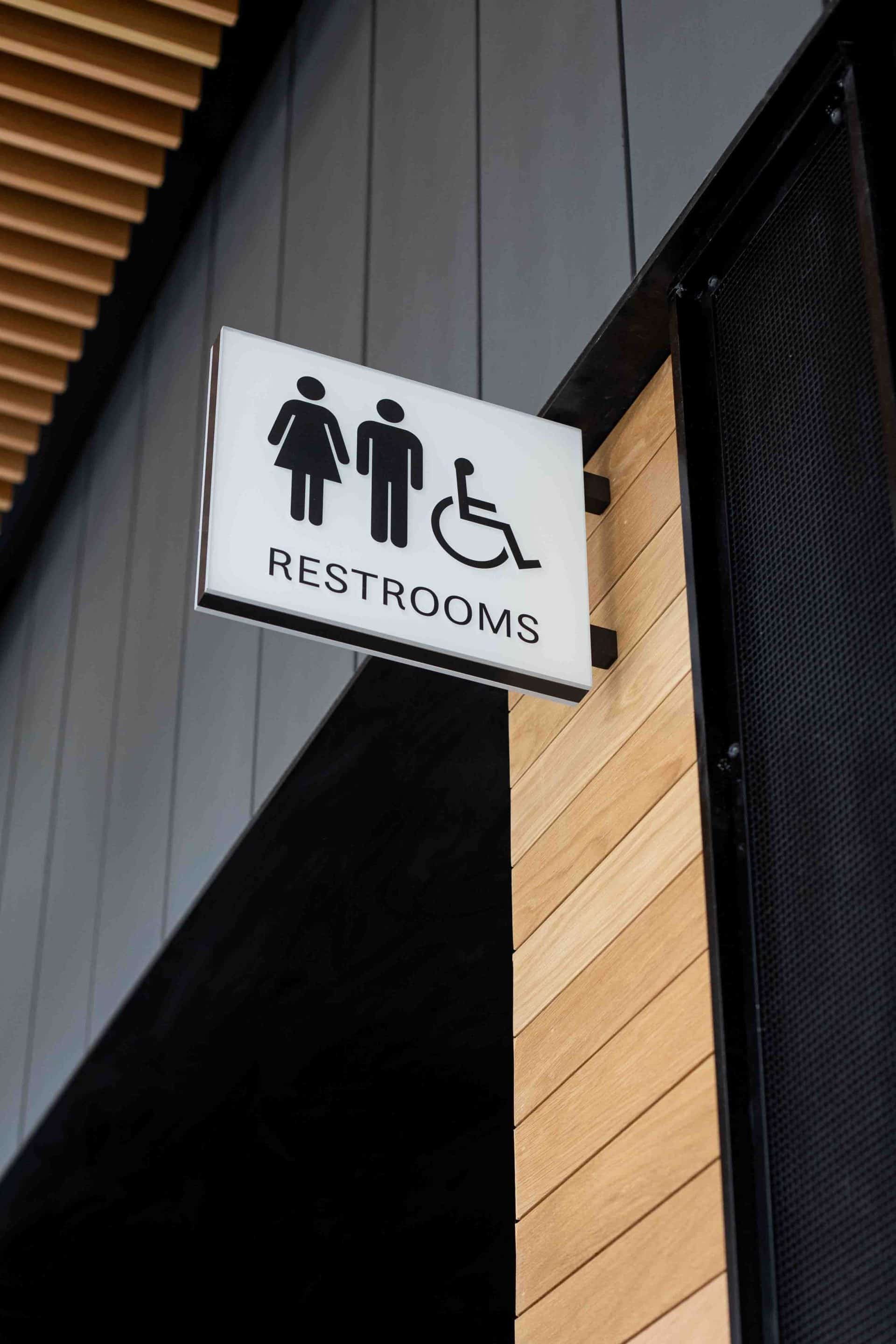 Custom restroom blade sign for visitors center