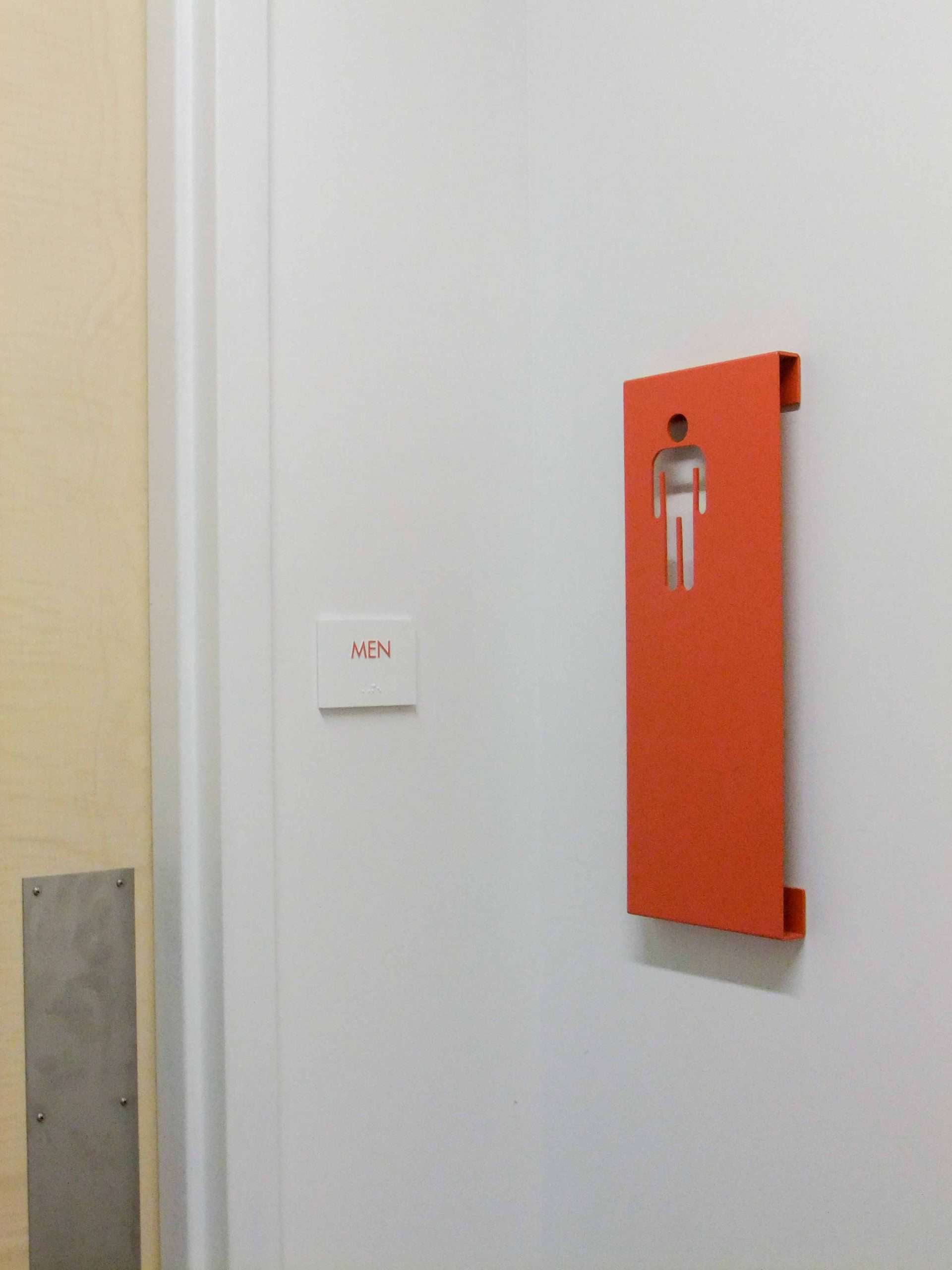Custom metal restroom sign in orange