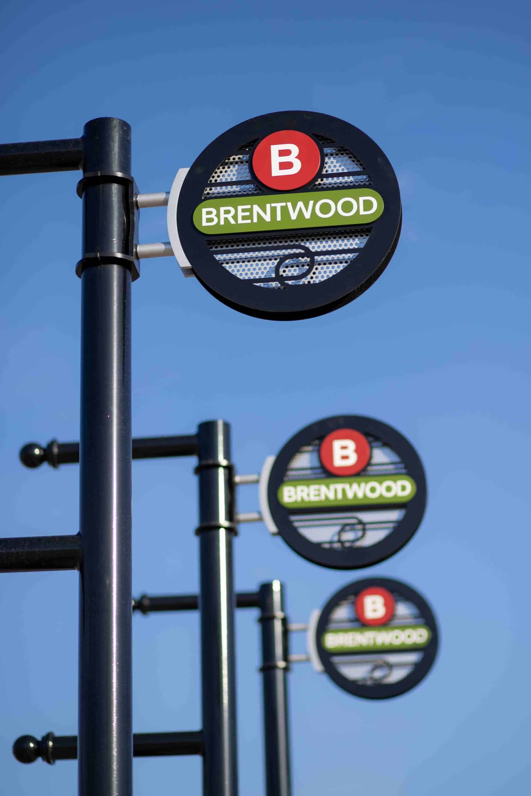 Custom poles to hold flags for Brentwood city with custom blade sign attachments with dimensional features