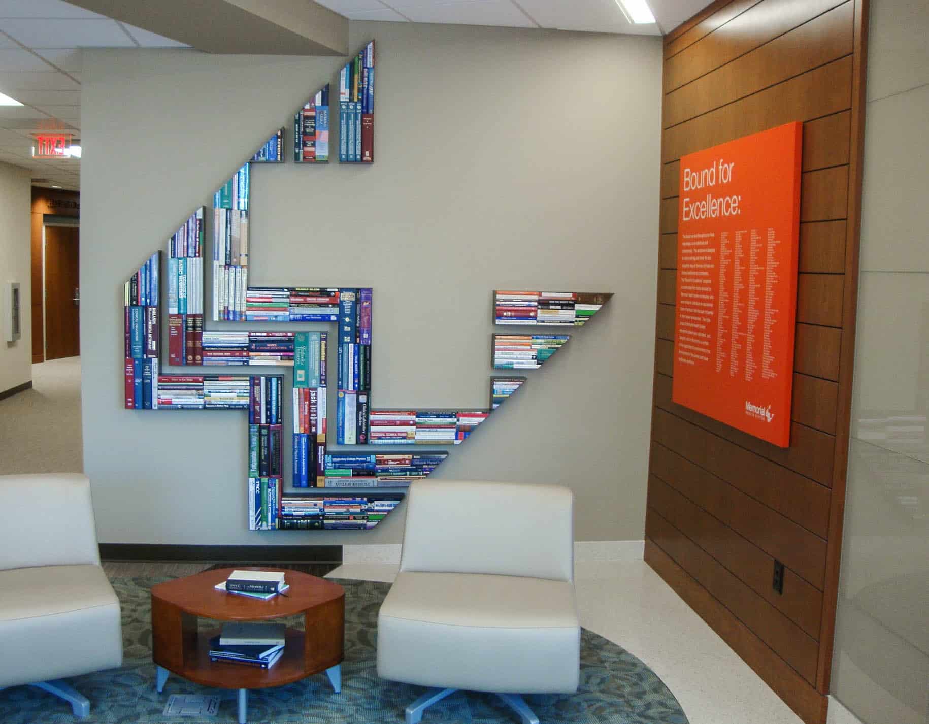 Custom logo wall made with books for Memorial Health Systems Environmental Graphics