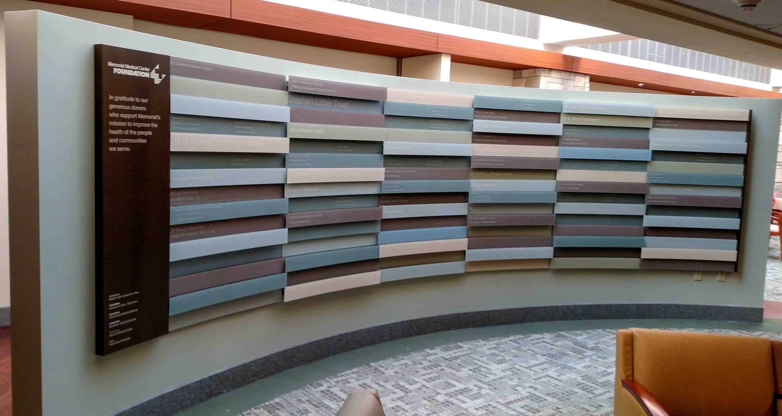 Different color panels at varying depths on curved wall for medical center foundation donors