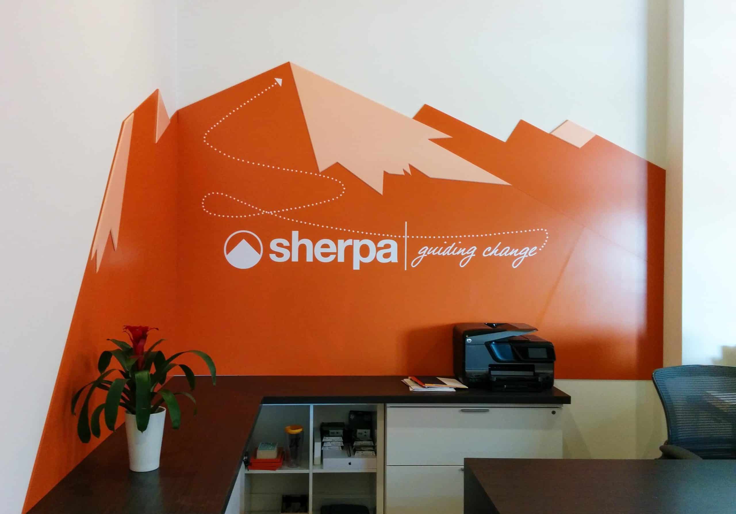 Vinyl graphic branding Sherpa space with mountain graphic and logo in white