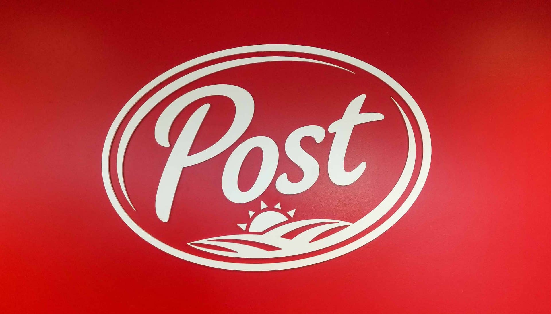 Post consumer Brands dimensional logo wall on red wall
