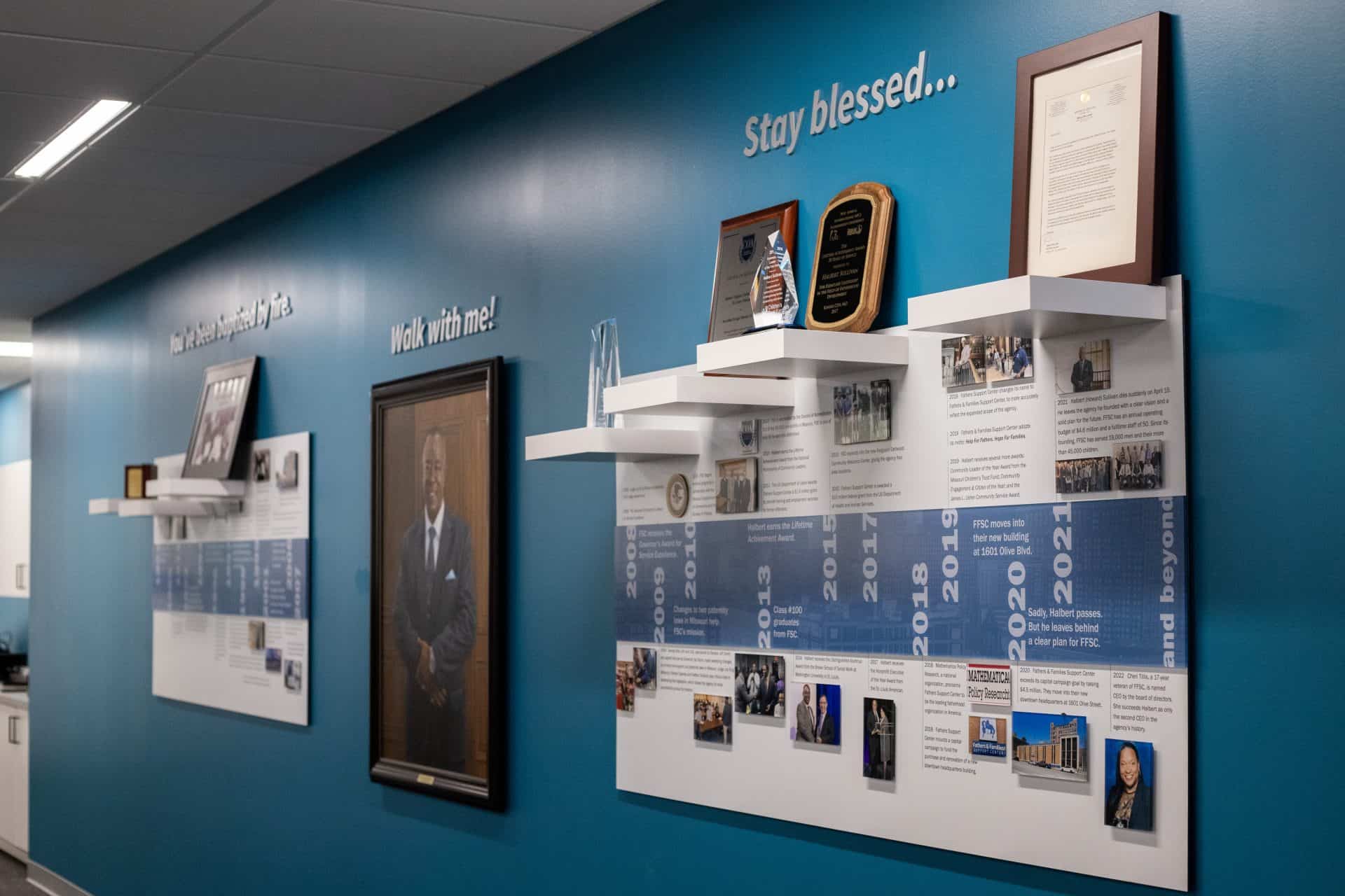 Timeline wall custom made with shelves to display historic artifacts and awards