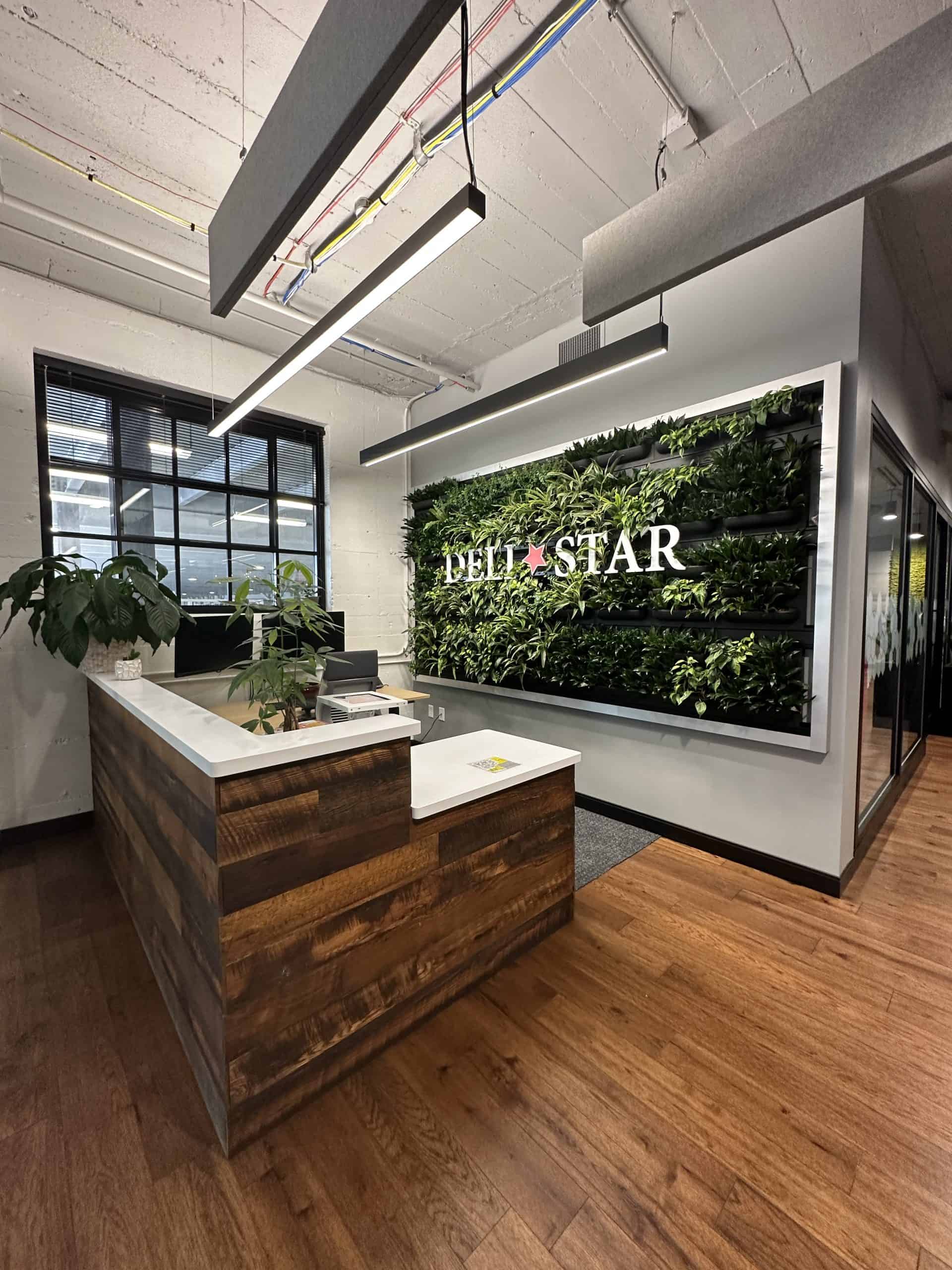 Lobby area with bold plant wall and logo