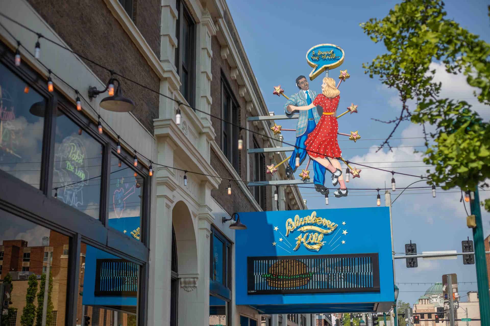 Custom restaurant sign hand painted dancers illuminated with neon