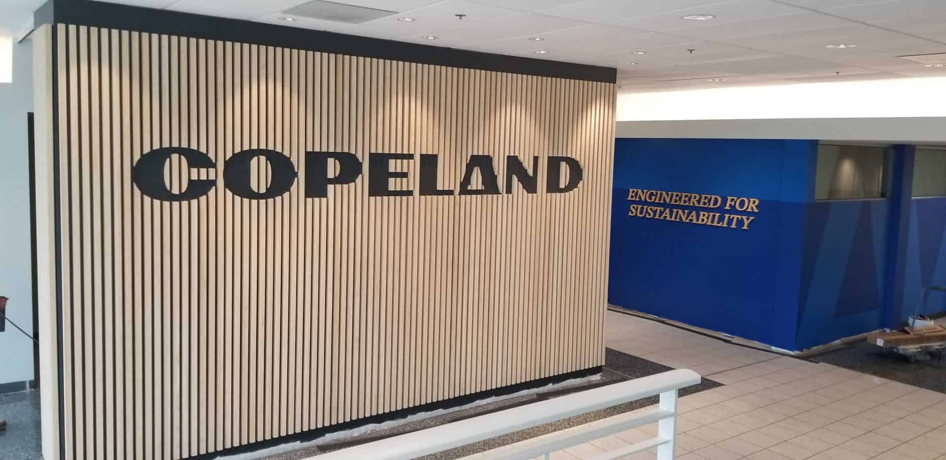 Copeland custom logo wall made with wood slates custom made for corporate offices